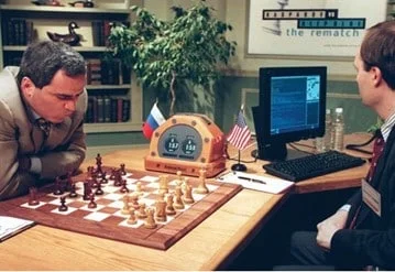 Kasparov vs Deep Blue: The Historic Human vs AI Chess Showdown Graphic depicting Garry Kasparov playing chess against IBM's Deep Blue computer, symbolizing the historic competition between human intelligence and artificial intelligence.